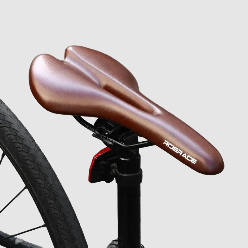 Brown bicycle seat with 'Rider Ace' branding on a gray pavement background