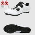 White cycling shoes with black soles and red cleats on a white background