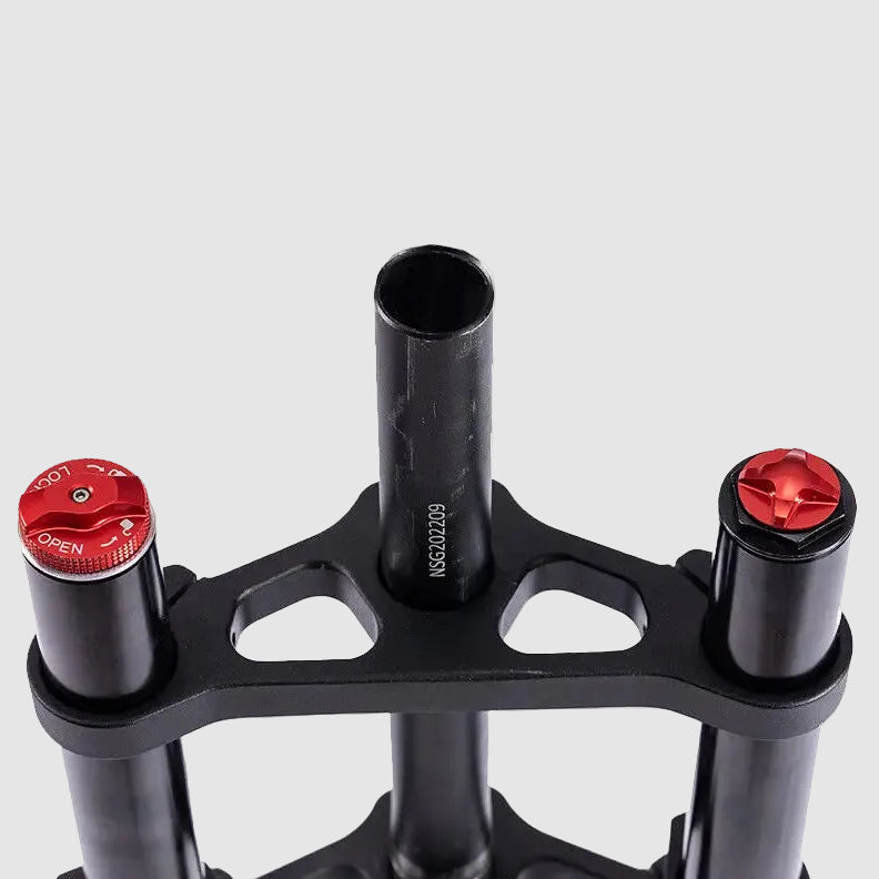 Close-up of a black metal bike frame with red accents on a white background.