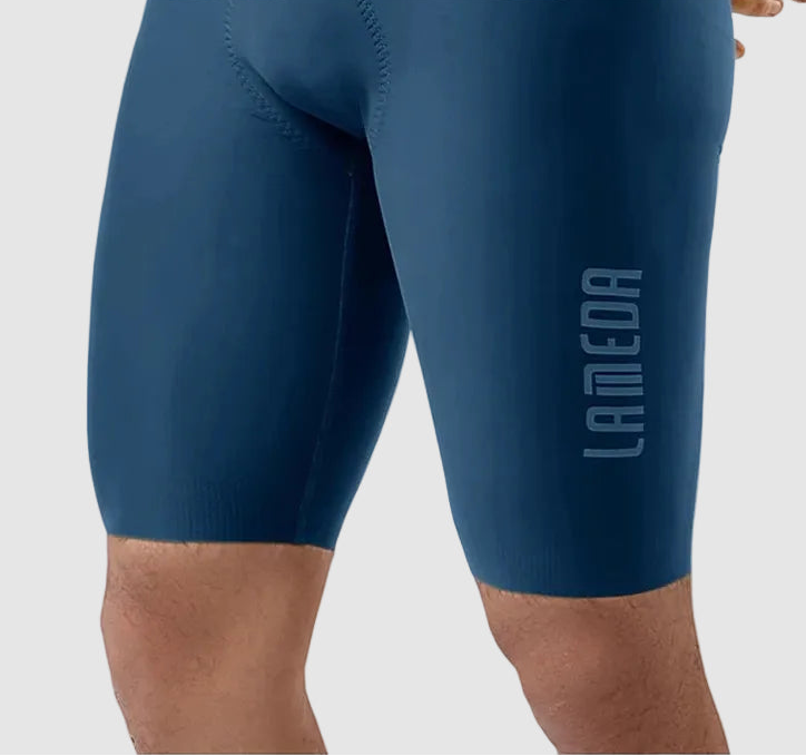 Blue athletic shorts with 'LAMEDA' branding on a light gray background