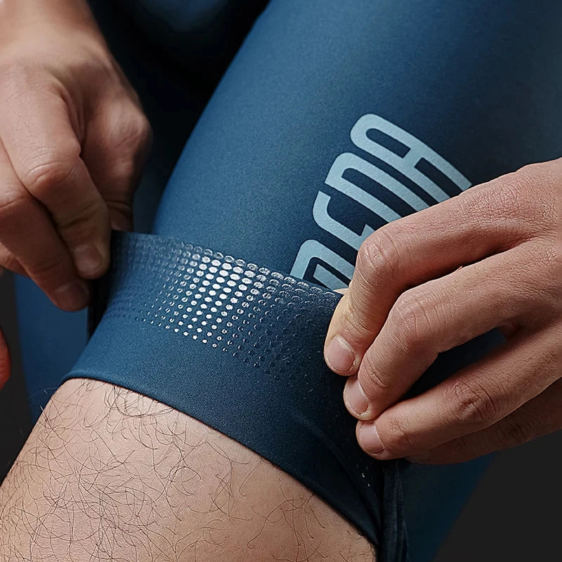 Person adjusting a blue compression garment with a brand logo on a dark background
