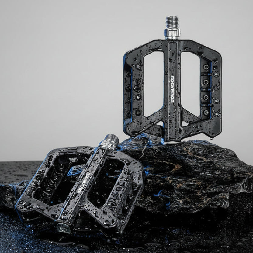 RockBros bike pedals on a dark background with water droplets
